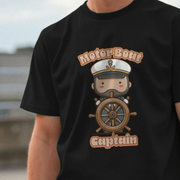 Black humorous graphic t-shirt with a cartoon character of a captain on a steering wheel and 'Motor Boat Captain' text.