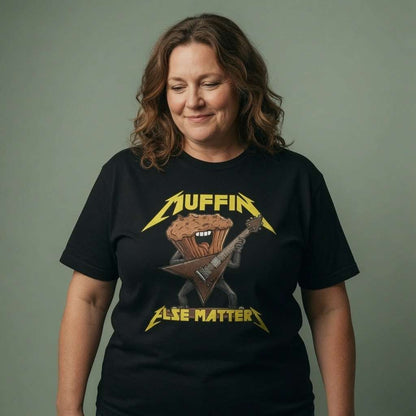 Woman smiling looking down in black Muffin Else Matters tee, ladies music inspired parody cake pun