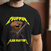 Black funny music t-shirt with a graphic of a muffin playing a guitar and the text 'MUFFIN ELSE MATTERS' on a blurred background.