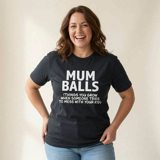 Woman laughing with hands on hips in black Mum Balls tee, fun cheeky relatable mum slogan