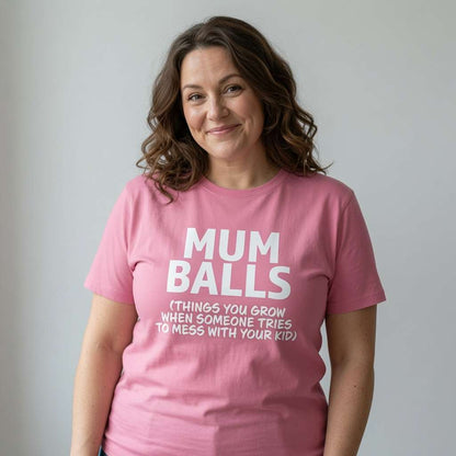 Woman with slight smile in pink Mum Balls t-shirt, witty relatable angry mum gift