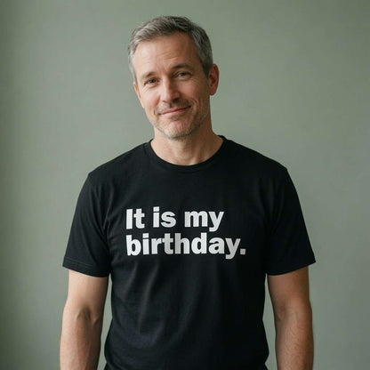 Man with grey hair smiling in black It is my birthday. tee, fun cheeky the ultimate birthday slogan