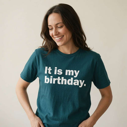 Woman laughing looking down with hands on hips in teal It is my birthday. t-shirt, humorous ladies birthday slogan gift