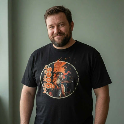 Bearded man smiling in black Watch him as he goes tee, music inspired drummer farewell graphic