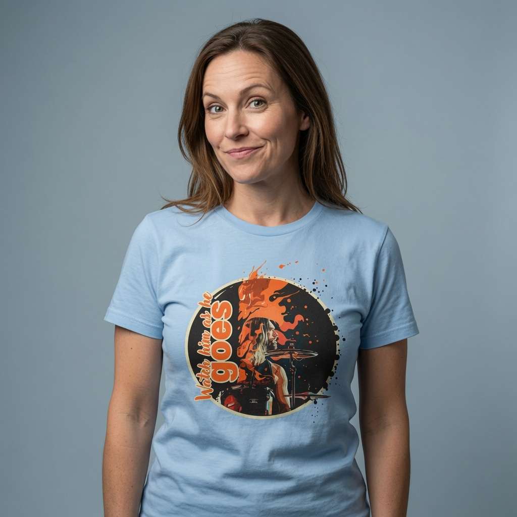 Woman with slight smile in sky blue Watch him as he goes t-shirt, ladies drummer music inspired