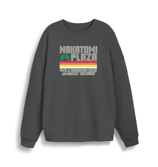 grey christmas sweater with a retro design and the slogan 'nakatomi plaza hotel and convention centre'