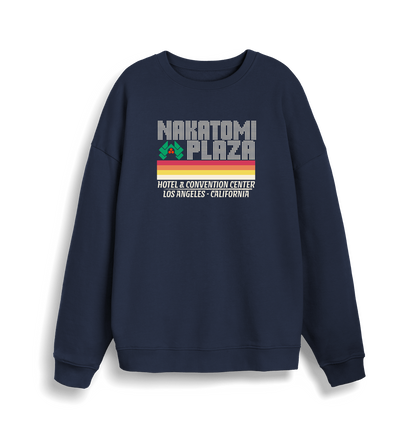 navy christmas sweater with a retro design and the slogan 'nakatomi plaza hotel and convention centre'