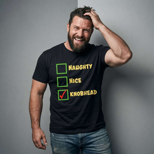 Bearded man laughing with hand in hair in black Naughty Nice Knobhead tee, mens witty rude christmas banter pub