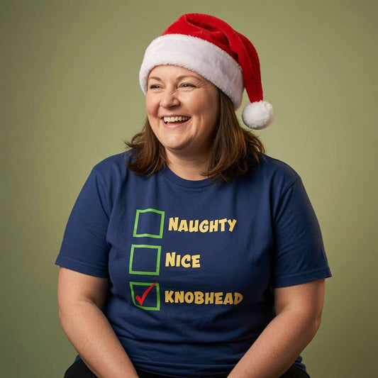 Woman laughing in Santa hat in blue Naughty Nice Knobhead tee, funny ladies xmas party banter