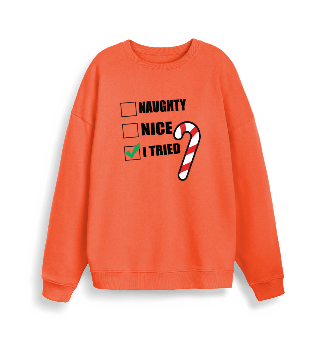 orange christmas sweater with the slogan 'naughty nice i tried'