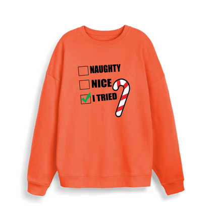 orange christmas sweater with the slogan 'naughty nice i tried'