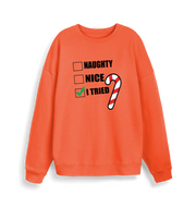 orange christmas sweater with the slogan 'naughty nice i tried'