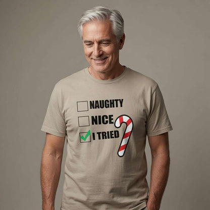 Man with grey hair smiling looking down in beige Naughty Nice I Tried t-shirt with candy cane, funny witty mens christmas party banter