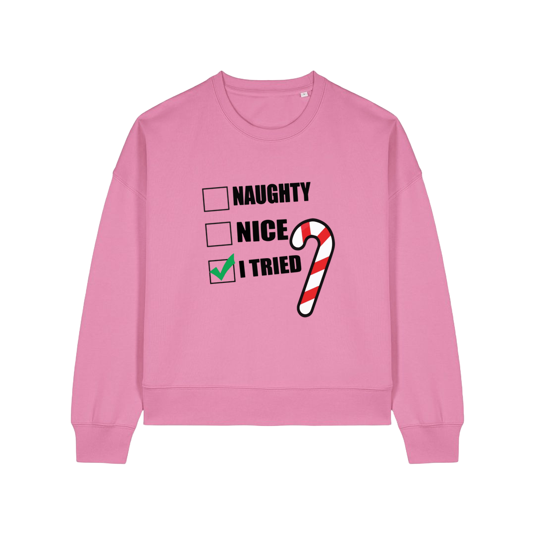pink christmas sweater with the slogan 'naughty nice i tried'