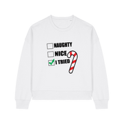 white christmas sweater with the slogan 'naughty nice i tried'