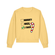 yellow christmas sweater with the slogan 'naughty nice i tried'