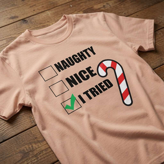 Peach Naughty Nice I Tried t-shirt on wood with candy cane design, fun ladies xmas party banter