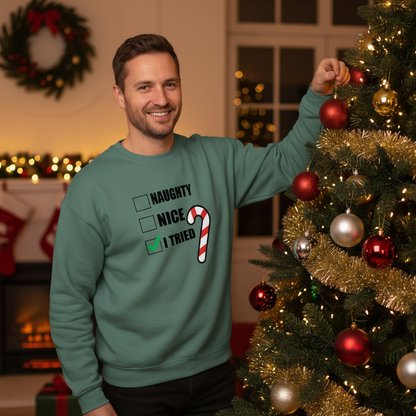 Man decorating a Christmas tree wearing a sweater with a candy cane design.