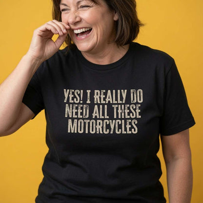 Woman laughing with one hand near her face while wearing a black Yes! I Really Do Need All These Motorcycles t-shirt, funny ladies motorcycle design that every no-nonsense lady will claim