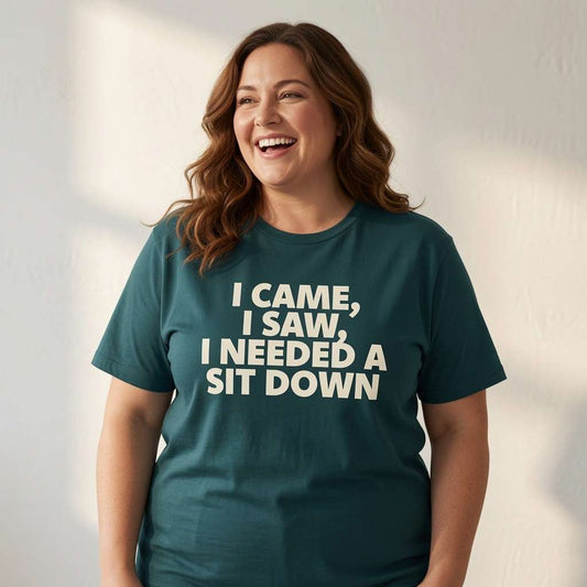 Woman laughing with her head tilted back while wearing a teal I Came, I Saw, I Needed a Sit Down t-shirt, fun and sarcastic age-related banter for ladies