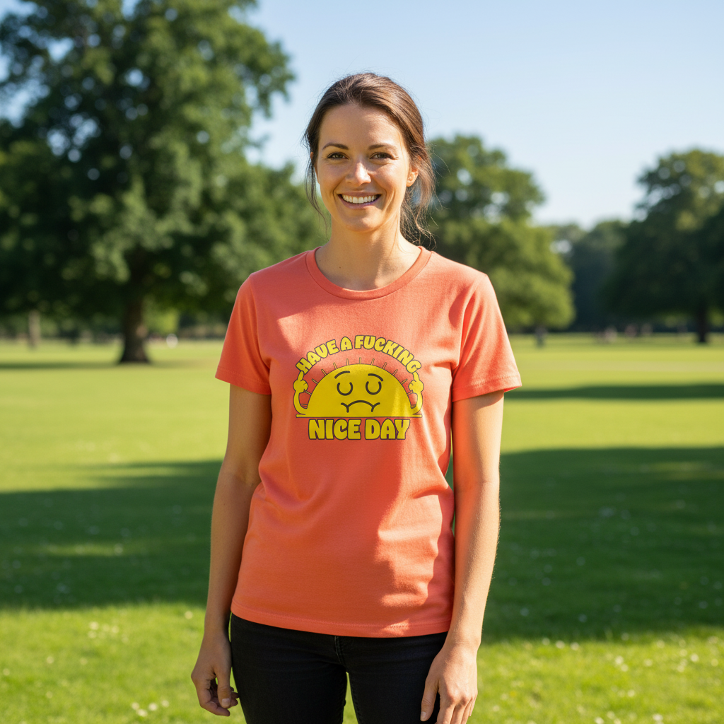 Woman wearing a pink t-shirt with a graphic design in a park