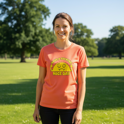 Woman wearing a pink t-shirt with a graphic design in a park