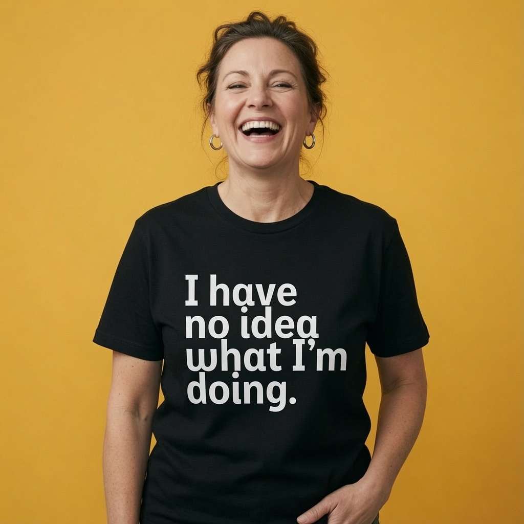 Woman laughing with one hand near her hip while wearing a black I Have No Idea What I’m Doing t-shirt, funny ladies witty slogan design that every no-nonsense lady will claim