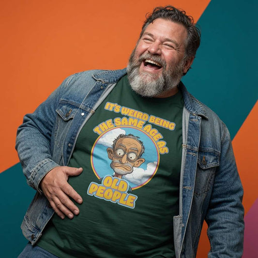 Man laughing in a denim jacket while wearing a green It’s Weird Being The Same Age As Old People t-shirt, funny mens sarcastic dad graphic design full of pure attitude