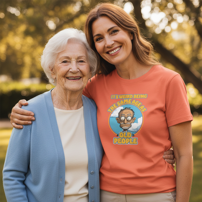 Two women standing together outdoors, one wearing a t-shirt with a humorous graphic and text.