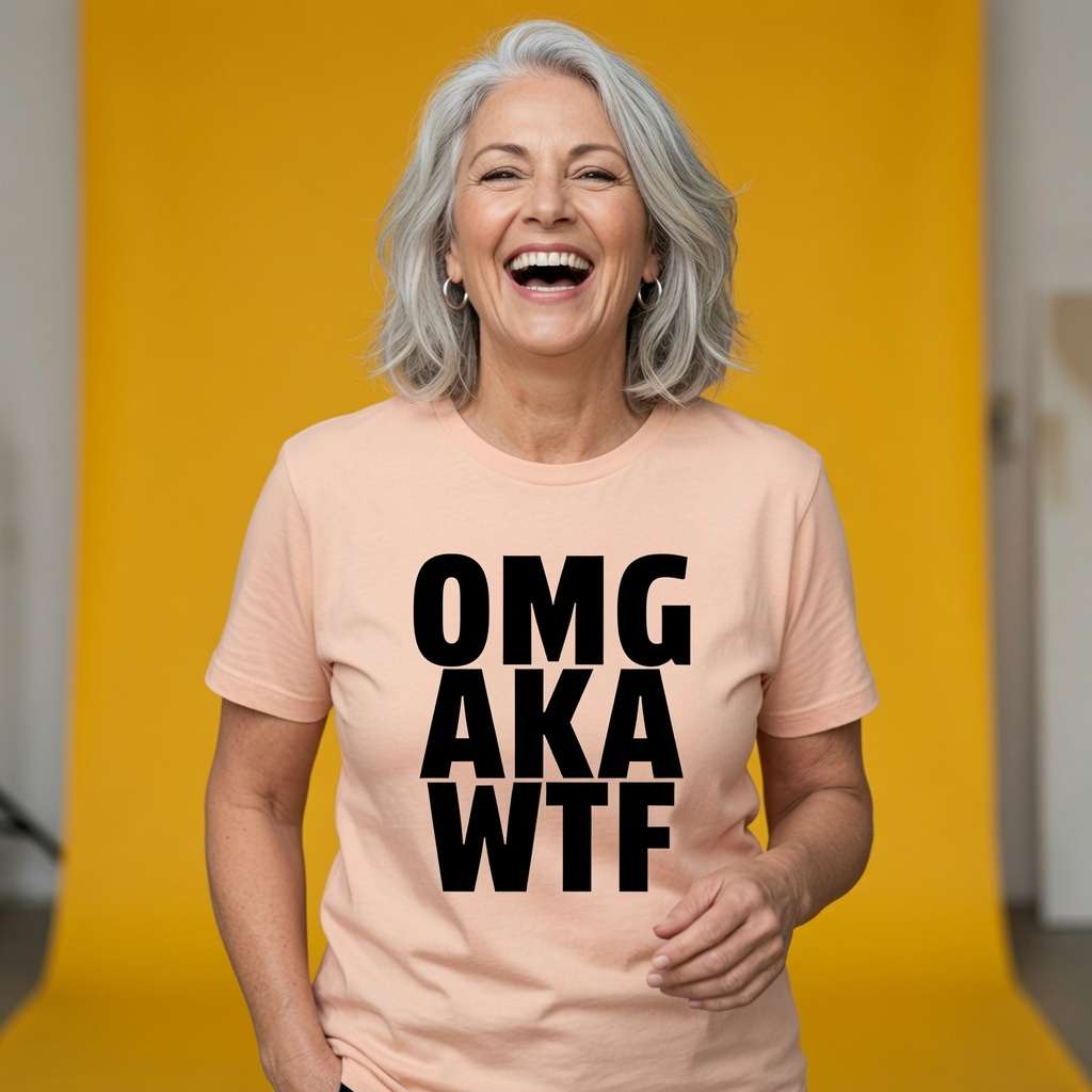 Woman laughing with silver hair while wearing a peach OMG AKA WTF t-shirt, witty ladies funny text design full of pure attitude
