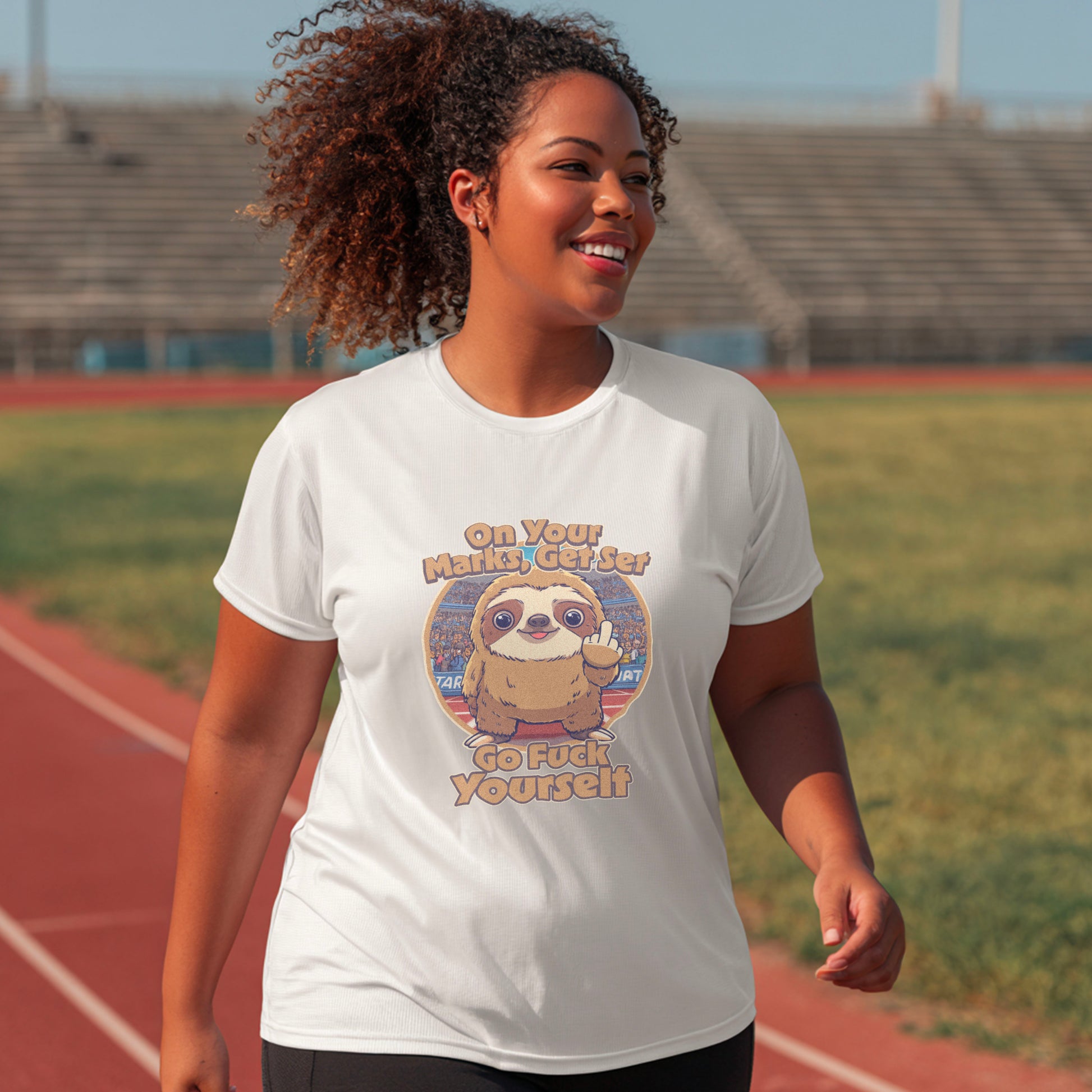 Person wearing a white t-shirt with a graphic design on a track and field background
