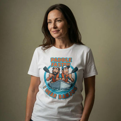 Woman with a soft knowing smile wearing a white Paddle Faster I Hear Banjos t-shirt featuring two panicked canoeists, hilarious film-inspired ladies graphic