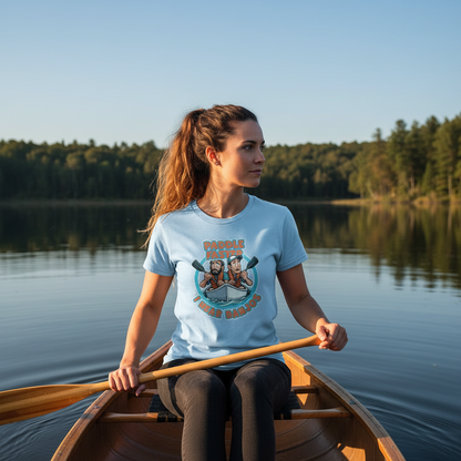 Woman in a canoe on a lake wearing a t-shirt with a graphic design.