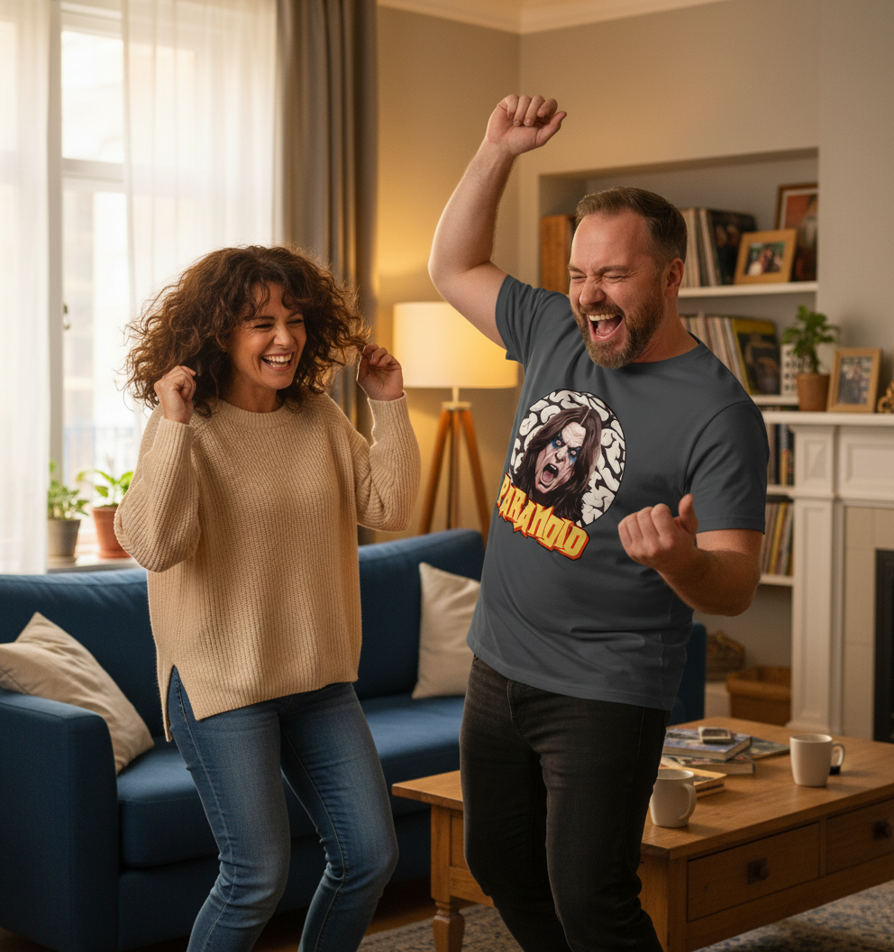 Two people dancing in a living room with a blue couch and coffee table.