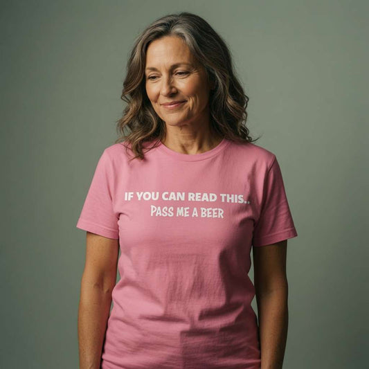 Woman smiling softly and looking slightly down in a pink If You Can Read This... Pass Me A Beer t-shirt, classic ladies pub banter slogan full of attitude