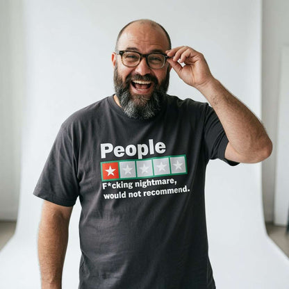 Bearded man laughing and adjusting his glasses while wearing a black People – F*cking nightmare, would not recommend t-shirt, funny and offensive review banter every cynic will claim
