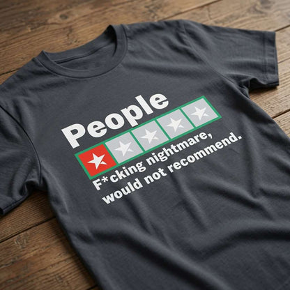 Ink grey t-shirt laid flat on a wooden surface featuring a one-star review graphic with the text “People – F*cking nightmare, would not recommend”, funny mens rude review design