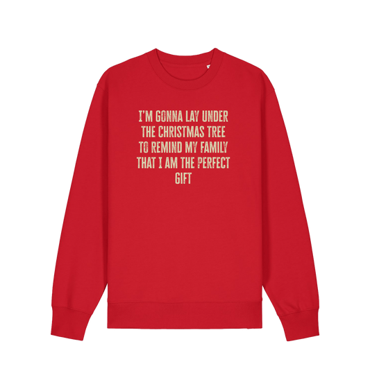 red christmas sweater with the slogan 'im gonna lay under the christmas tree to remind my family that i am the perfect gift'