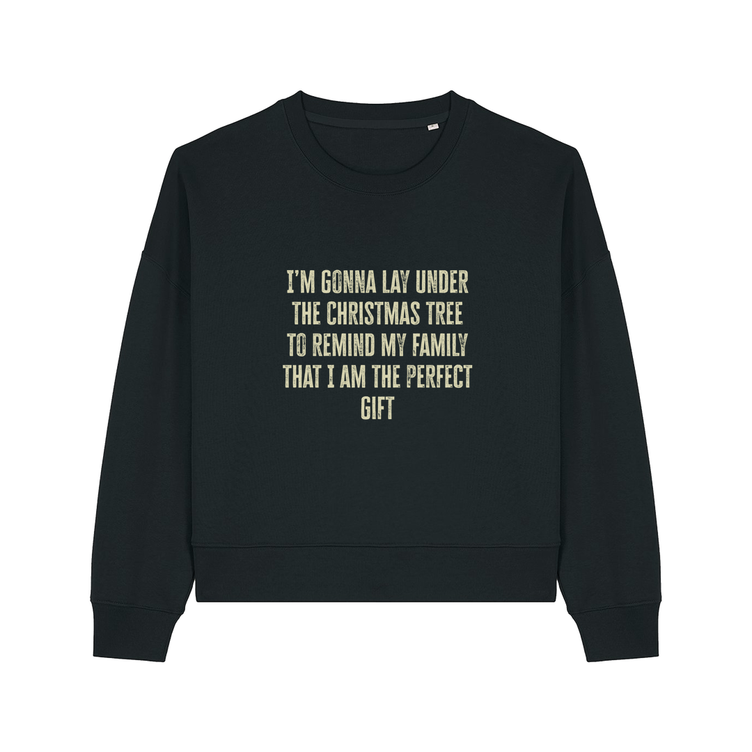 black christmas sweater with the slogan 'i'm gonna lay under the christmas tree to remind my family that i am the perfect gift'