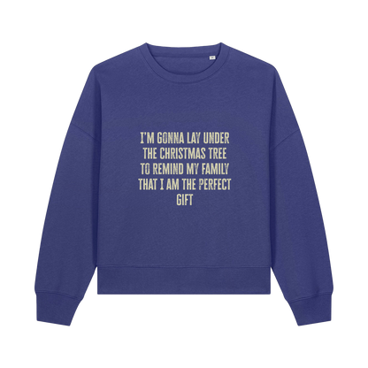 blue christmas sweater with the slogan 'i'm gonna lay under the christmas tree to remind my family that i am the perfect gift'