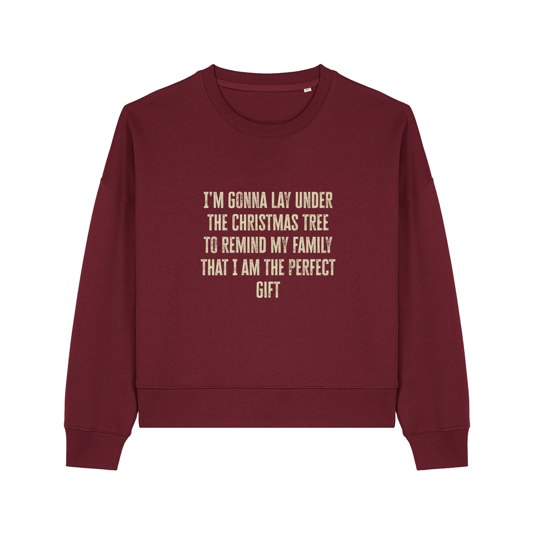 burgundy christmas sweater with the slogan 'i'm gonna lay under the christmas tree to remind my family that i am the perfect gift'