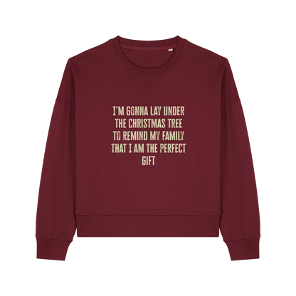 burgundy christmas sweater with the slogan 'i'm gonna lay under the christmas tree to remind my family that i am the perfect gift'