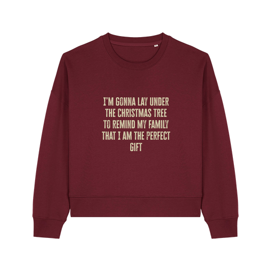 burgundy christmas sweater with the slogan 'i'm gonna lay under the christmas tree to remind my family that i am the perfect gift'
