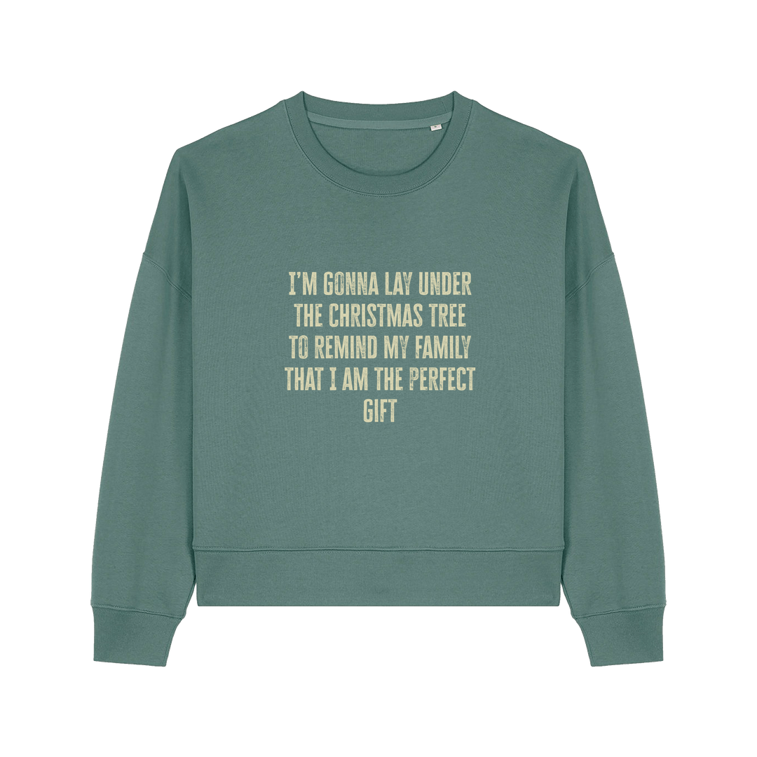 green christmas sweater with the slogan 'i'm gonna lay under the christmas tree to remind my family that i am the perfect gift'