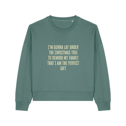 green christmas sweater with the slogan 'i'm gonna lay under the christmas tree to remind my family that i am the perfect gift'