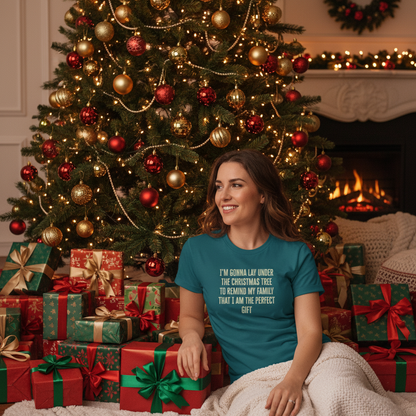 Woman sitting in front of a Christmas tree with presents and fireplace in the background
