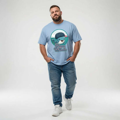 Bearded man standing with hands in his pockets while wearing a light blue Perm Whale t-shirt featuring a smiling sperm whale with a big afro, funny sperm whale graphic pun design