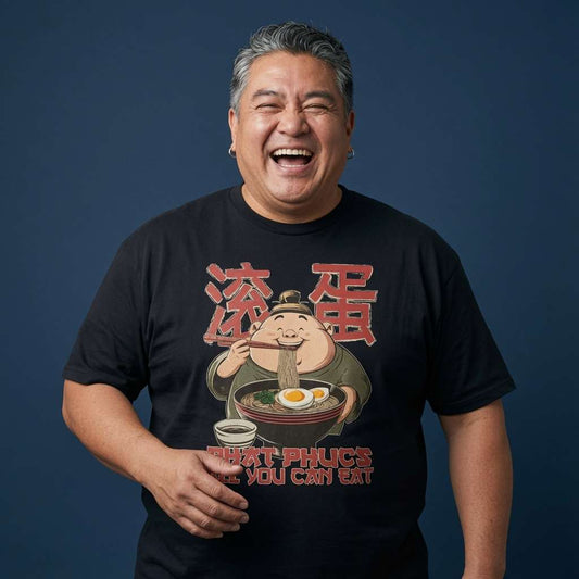 Man laughing while wearing a black Phat Phucs All You Can Eat t-shirt, humorous Chinese lettering takeaway pun graphic full of pure attitude