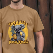 Brown fun animal t-shirt with a koala graphic and text 'Yes I Like Pina Koala' against a wooden background.