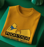 yellow music t-shirt sat on a green backdrop with the graphic of a cartoon bear and 'pooh tang forever'  